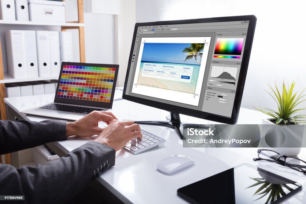 Blogom close up of a designer's hand editing photo on computer in office